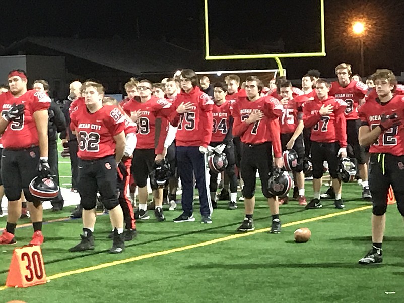 The Red Raiders stand at attention for the National Anthem, prior to their big win Thursday night against Washington Township. 