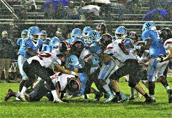 The Red Raiders slug it out against Highland last Friday in rainy and windy conditions. (Photos courtesy OCHSfootball.com)