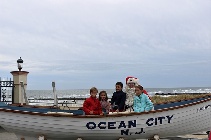 Four children pose for photos with Santa and tell him what they want for Christmas.