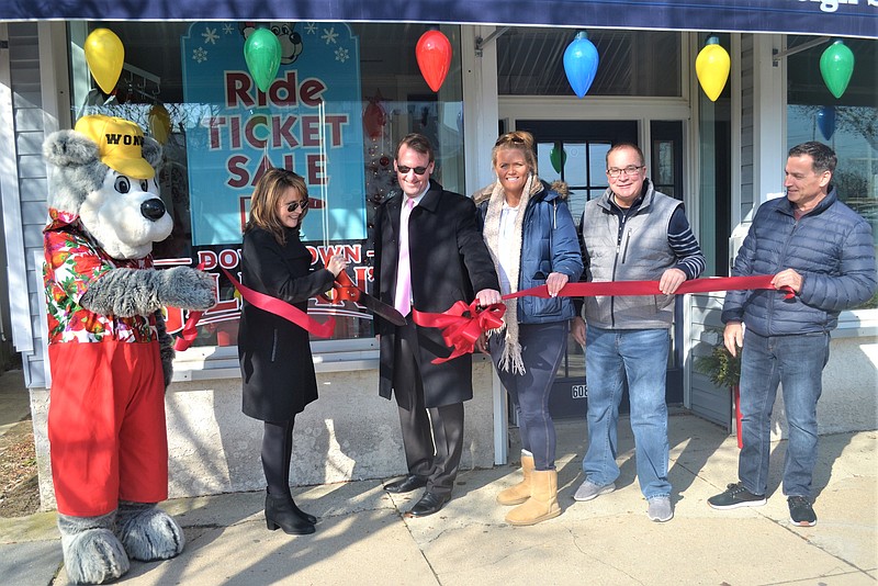 From left, as the Wonder Bear mascot looks on, Chamber of Commerce Executive Director Michele Gillian, Mayor Jay Gillian, employee Holly Kisby, manager Gary Foley and Chamber President Dave Allegretto celebrate the grand opening of Gillian's Downtown with a ribbon-cutting ceremony. (Photo courtesy of Chamber of Commerce)