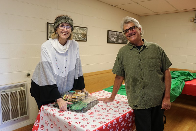 Julie Baumgardner, of Upper Township, and husband, Mike Perkins, share some laughs as they set up for the Christmas Dinner at St. Peter's Methodist Church. 