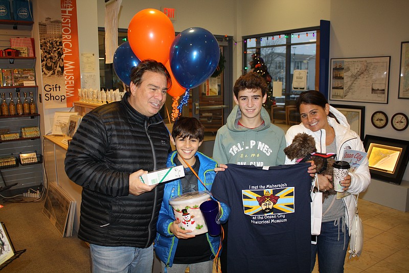 Jonathan Golluber, left, his sons, Cody and Lucas, his wife, Lisa, and the family dog, Luna, enjoy their visit to the Ocean City Historical Museum as the 10,000th visitor. (Courtesy Ocean City Historical Museum)