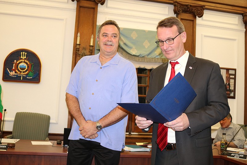 Mayor Jay Gillian reads a city proclamation honoring retired Fire Department Capt. Gary Green for his 35 years of service.