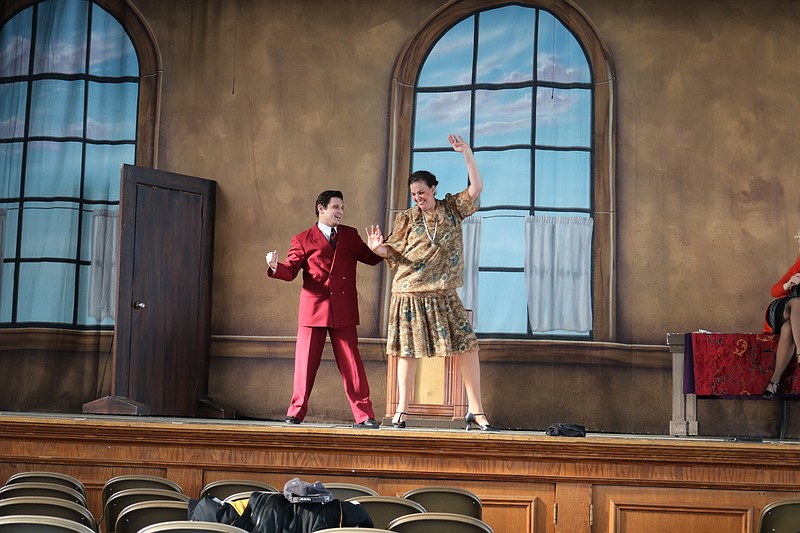 The actors in the roles of Rooster and Miss Hannigan run through a musical number.