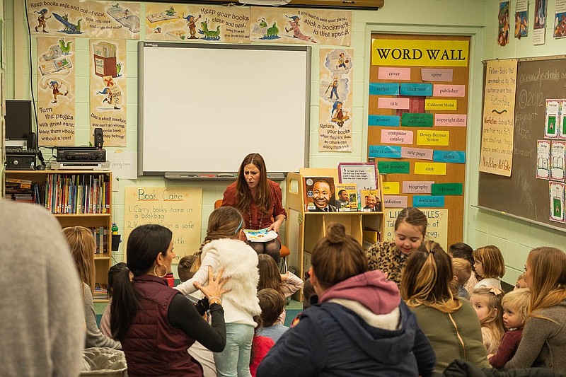 Reading Specialist Jen Gatto reads to the children. (Photo by Ben Hale, JASM Consulting)