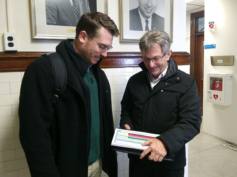 Danny Dierdorff. left, and Rick Jones, both of Universal Media based in Mechanicsburg, Pa., look over their marketing propposal for 2019 outside Council Chambers. 