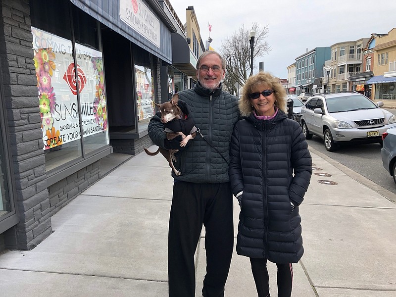 Bill and Emily Marks stroll Asbury Avenue with their dog Marty.