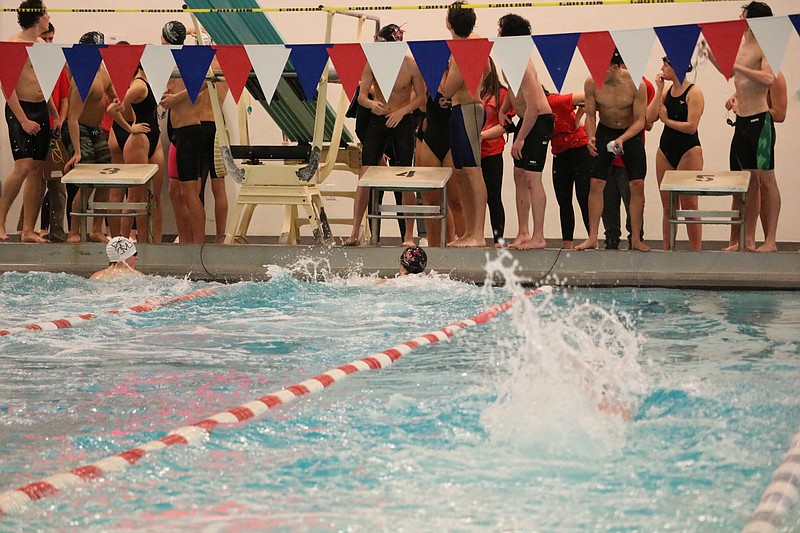 Swimmers hit the finish line in the Ocean City boys' school record in the 200 meter free relay.