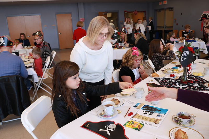 Carol Dotts stops to chat with Maycee Capille, 9, of Egg-Harbor Township during "high tea."