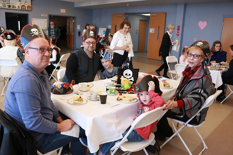 The Moffitt family enjoy tea and finger foods after the pirate presentation.