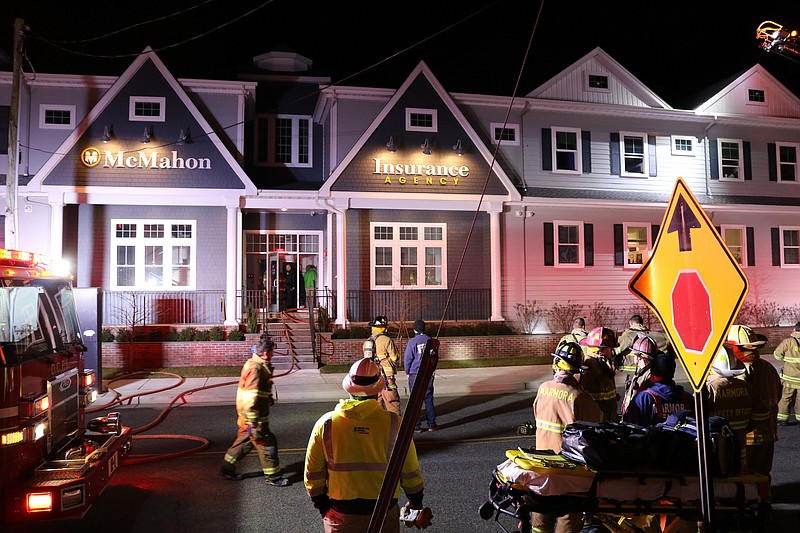 Firefighters respond to the McMahon Insurance Agency building on Sunday night.