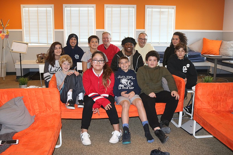 The Epic room is a place for the older students to come for Bible lessons and activities. Sharing a moment with the students are at left in back with hat on is Jonathan Gonzalez, sitting next to Pastor Jay Reimer, Noah Pratt, David Knauss and Corrie Stevenson. 