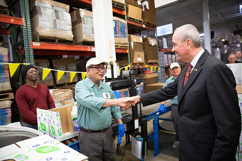 Gov. Phil Murphy, right, shaking the hand of a worker, believes a higher minimum wage will help stimulate business in New Jersey. (Courtesy of Gov. Phil Murphy Facebook page)