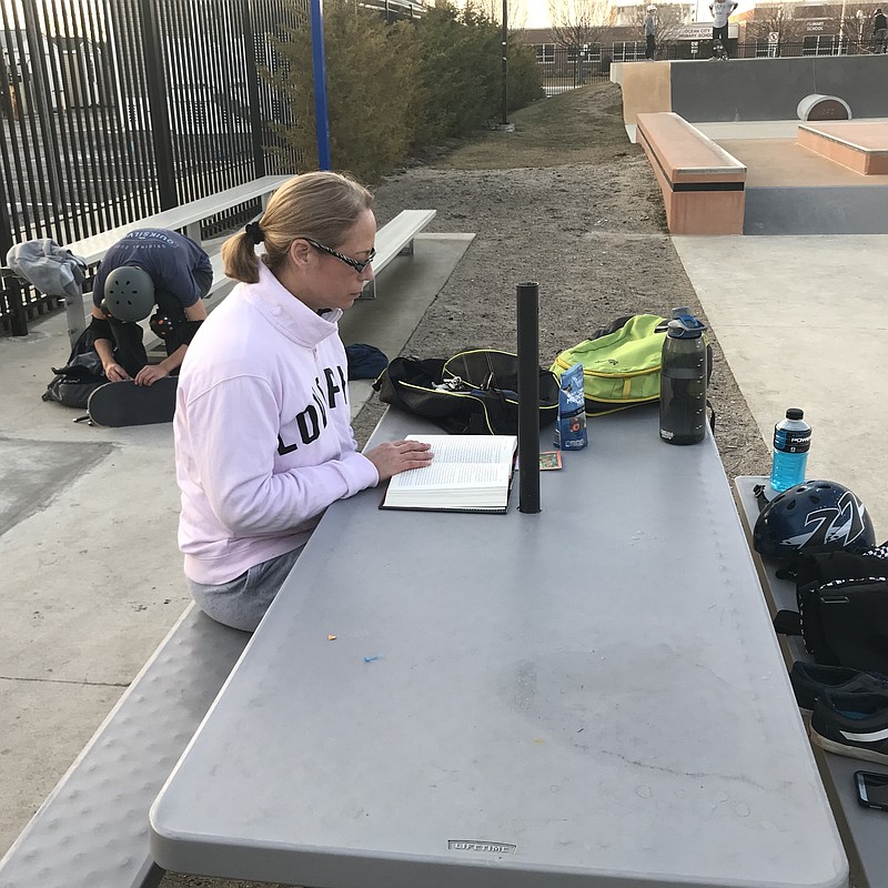 You might not think of a skateboard park as a place to catch up on your reading, but that didn’t stop mom Lora Fenstermacher on Tuesday.