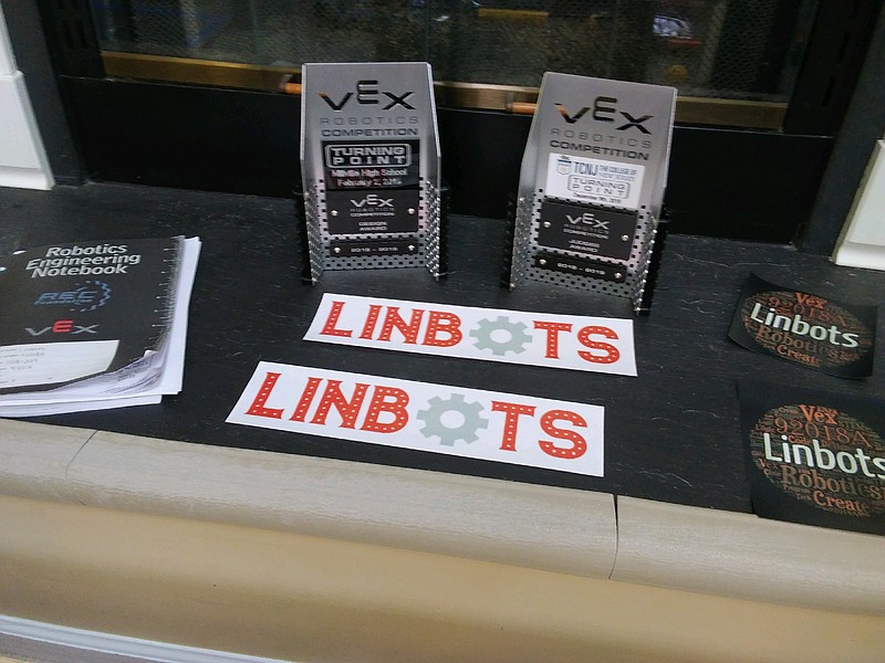 Team awards are placed on the fireplace to showcase the accomplishments of the "Linbots."