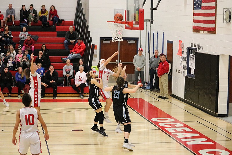 Danielle Donoghue works inside to score a basket over two defenders.