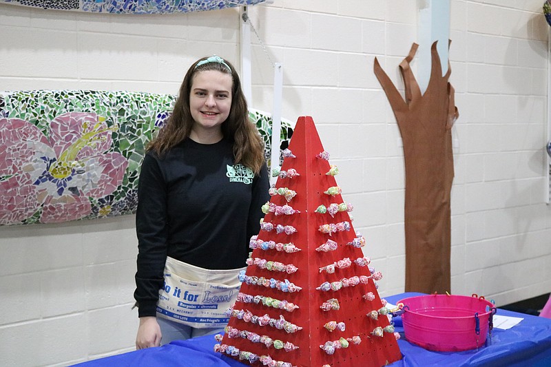 Taylor Stauffer, a high school freshman and member of the Drama Club, oversees the lollipop booth.