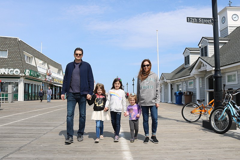 Adam and Meghan Hubley, of Mullica Hill, N.J., stroll the Boardwalk with their daughters Ava, Sadie and Adelina at the start of Easter weekend.