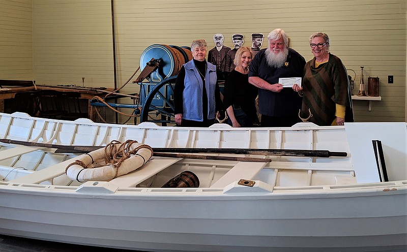 Richard Somers Questers Chapter 1148 members Pat Crowley (left), Carol Dotts and Suzanne Hampton present U.S. Life-Saving Station 30 Chairman John Loeper with a check for oar locks. (Courtesy Questers 1148)