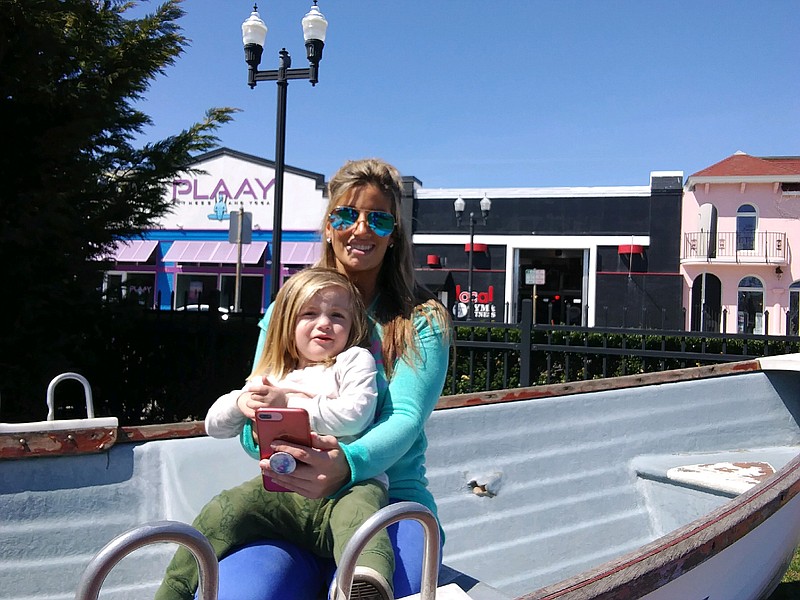 Nicole Farina, of Ocean City, and her son, Jack, 2, take a break in a boat at Mark Soifer Park in between Girls Weekend.