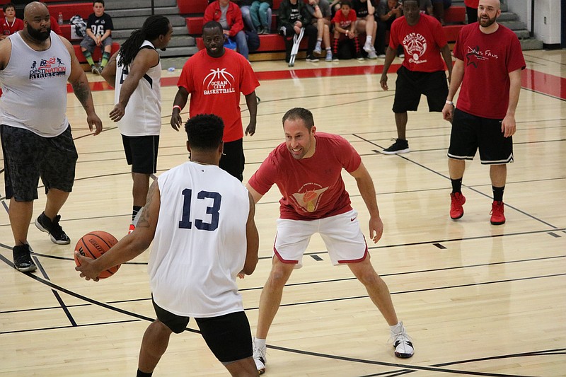 City Council President Pete Madden, right, defends against the all-stars.