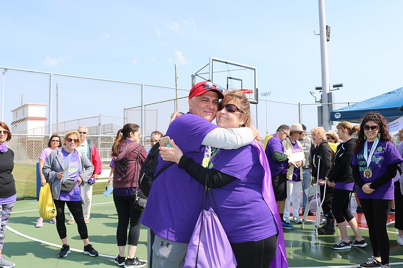 Lupus patient Linda Roselli receives a hug from her husband, Anthony.