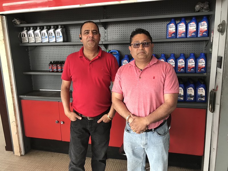 Bobby Sharma, left, and Varinder Kumar were both working at the reopened Grace Oil station on Wednesday 