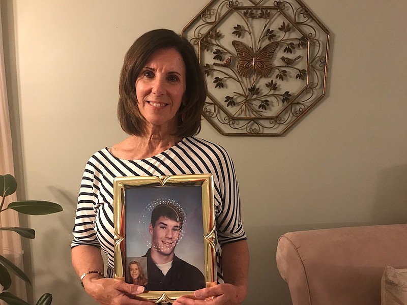 Kathy Moretti, of Cape May Court House, holds up an Ocean City High School photo of her son, Ronnie, 16, who was killed in 1991 by a drunken driver. (Photos courtesy Kathy Moretti)