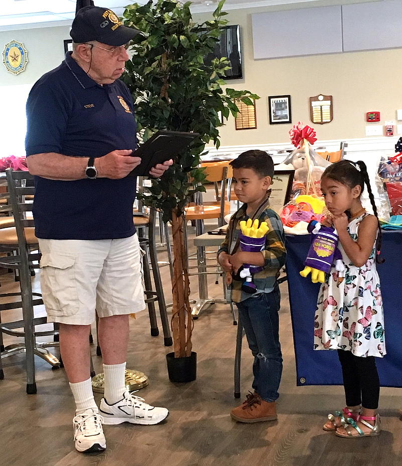 Post 524 veteran Steve Cole presented Mason and Isabella Pazmino                        with a commendation medal and a special citation for demonstrating strength while their father was deployed overseas.