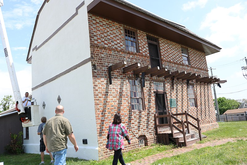 Volunteers from The Patriots of The Somers Mansion survey the mansion.