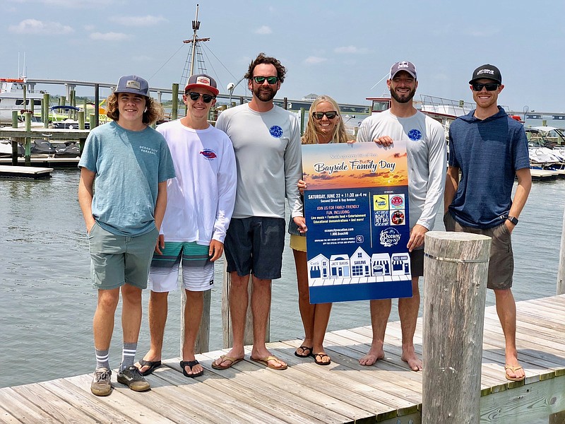 Back Bay Committee members gather on the dock to plan the inaugural Bayside Family Day event.