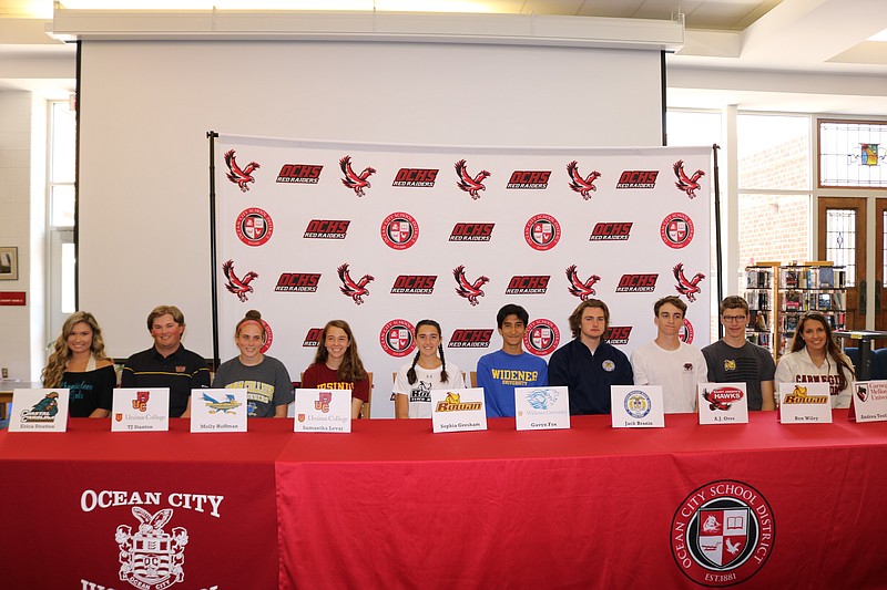 A dozen student-athletes at Ocean City High School made their college commitments during a signing ceremony Monday. Two of the students were absent from the event.