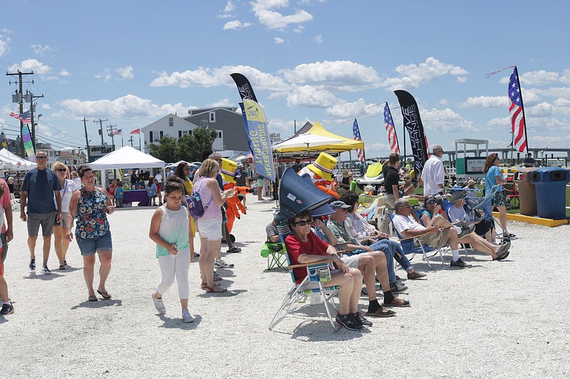 Crowds listen to live music by "Tidal Wave" at Bayside Family Day.