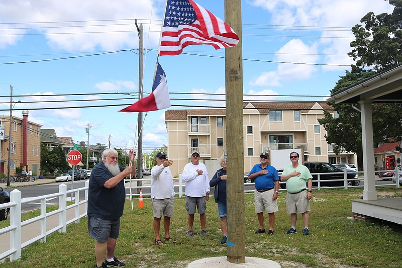 John Loeper raises the flag recently at the U.S. Life Saving Station 30.