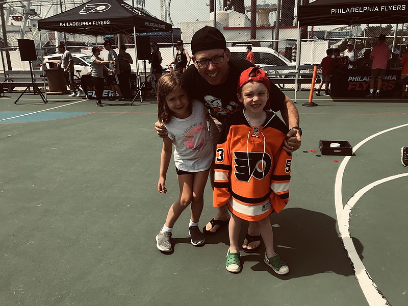 John Grant and kids Riley, 7, and Breandan, 5, of Fallston, Md., enjoy a family day at the Flyers Community Caravan.