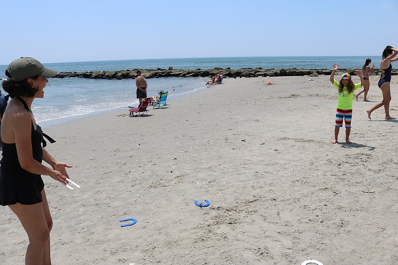 Robyn Morningstar, of Philadelphia, and her daughter, Ella, 7, enjoy a game of horseshoes.