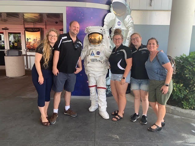 Substitute teacher, Lee Styer, Dan Weaver, physics teacher, and advisor for the SSEP, Abigail Cragie, Madison Morgan and mom, Sue Morgan, who is also a School Board member pose for a photo.