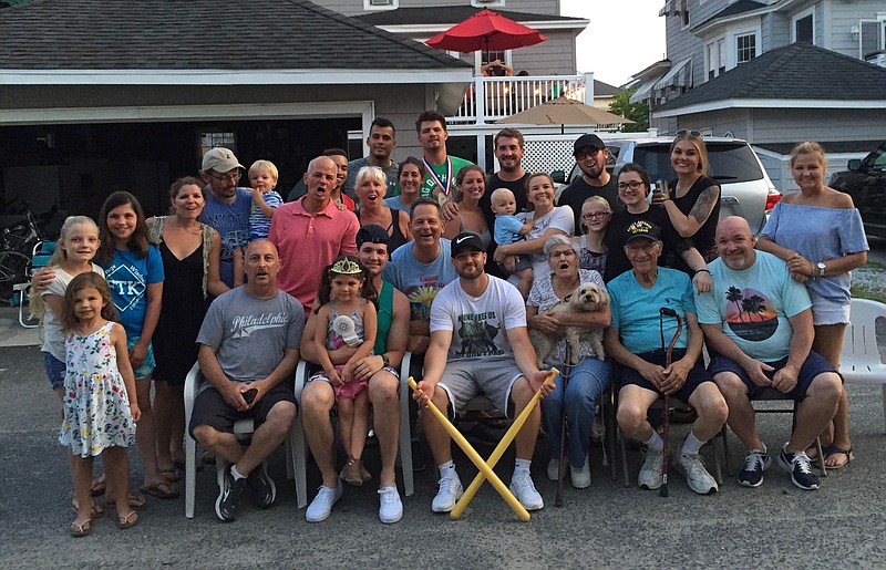 Wiffle ball enthusiasts of all ages pose for a group photo.