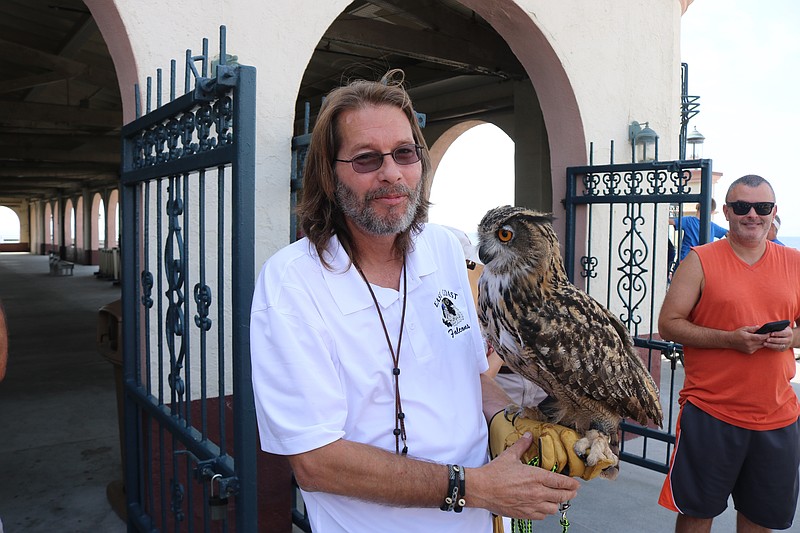 Ozzy the owl, held by East Coast Falcons owner Erik Swanson in 2019.