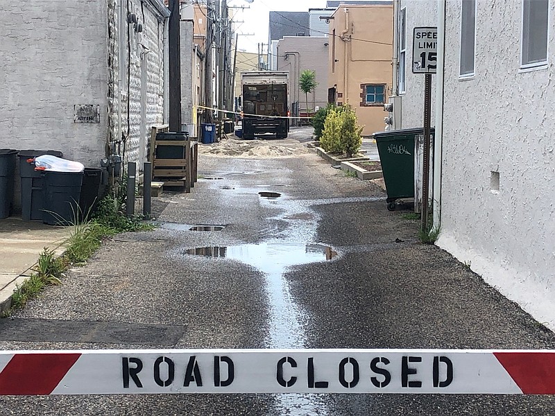 Sand is spread in an alley where the chemical spill occurred.