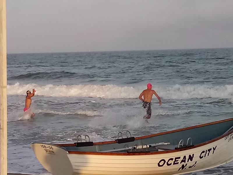 Ocean City's Liam Garbutt charges into the surf to start the swim portion of the swim-row rescue event.