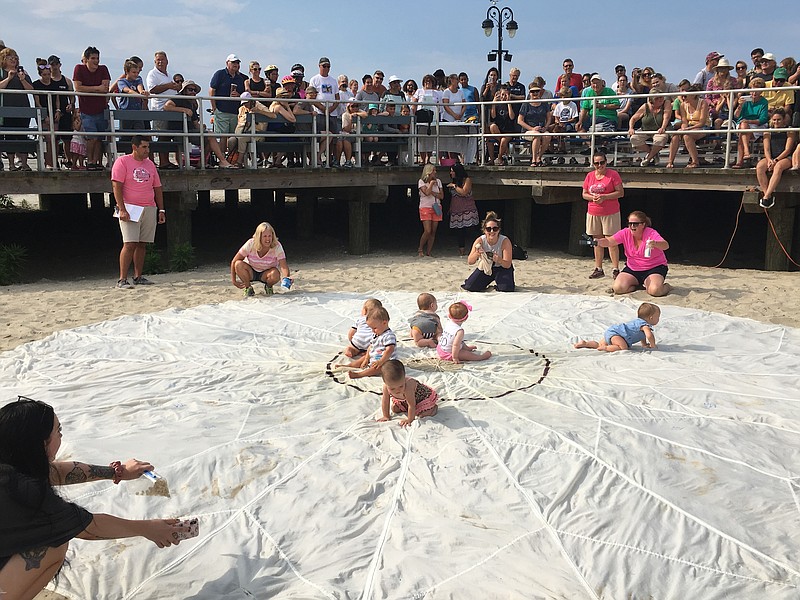 A parachute spread out on the beach serves as the Pamper Scamper's race course.