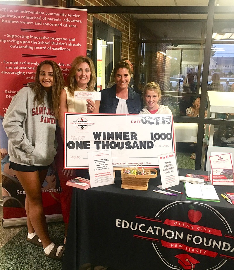 Senior Juliette Shirk and her mother, Education Foundation Vice President Jennifer Shirk, sixth-grader Lexi and her mother, foundation board member Heather James, display a donation check at the Primary School. The foundation will host a fundraiser Oct. 19.(Photo courtesy Jennifer Shirk)