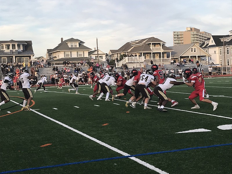 Ocean City's defense closes in on Absegami QB Ray Weed in the first quarter.