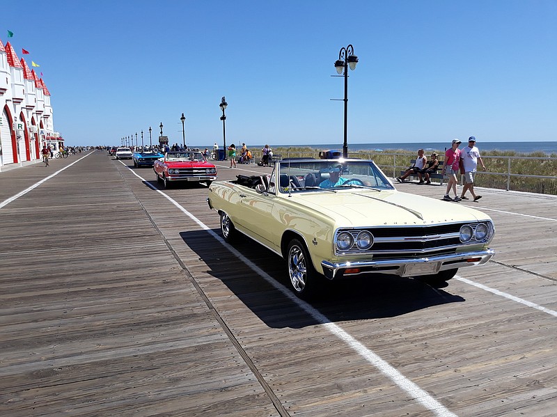 A colorful parade of antique cars rolls down the Boardwalk.