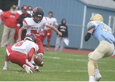 Brandon McGonigle gets off one of his five extra-point kicks, out of Brian Beckman’s hold.