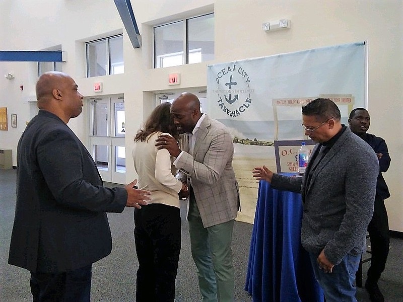 Pastor Ted Winsely speaks to an audience member after the program.