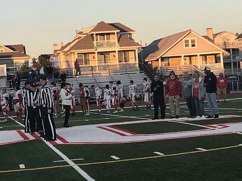 OCHS alums who are military veterans take part in the pre-game festivities Friday night at Carey Stadium before the football victory over Triton.