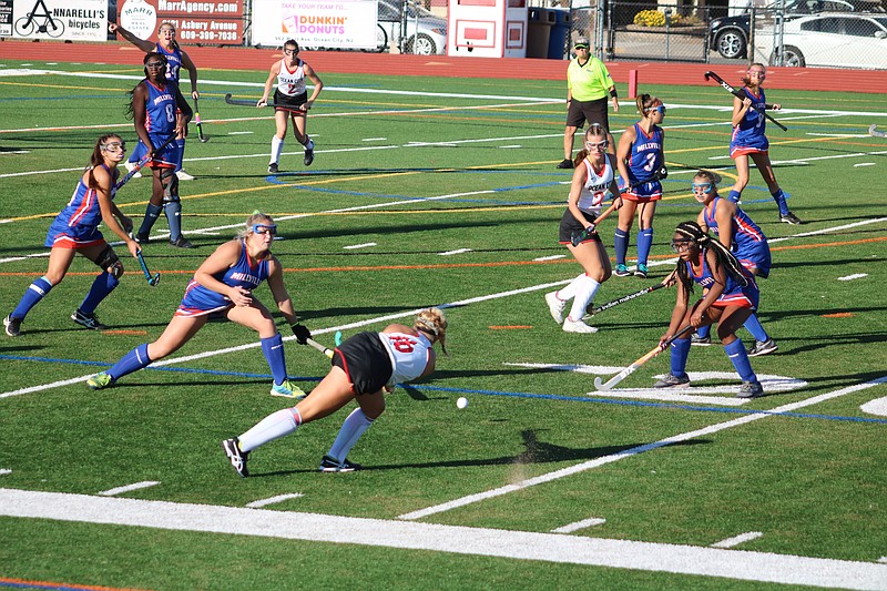 Ocean City's Morgan Pizagno (16) clears the ball to teammate Molly Reardon (2).