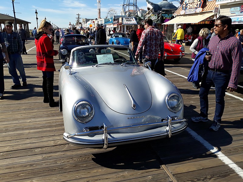 Car buffs marvel over a a classic silver convertible Porsche on display in 2019.